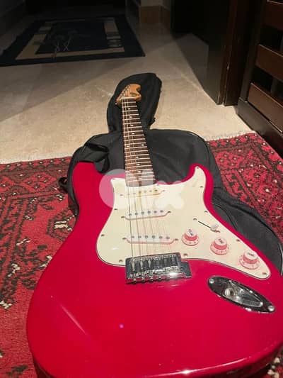 red on white stratocaster with amp and cables